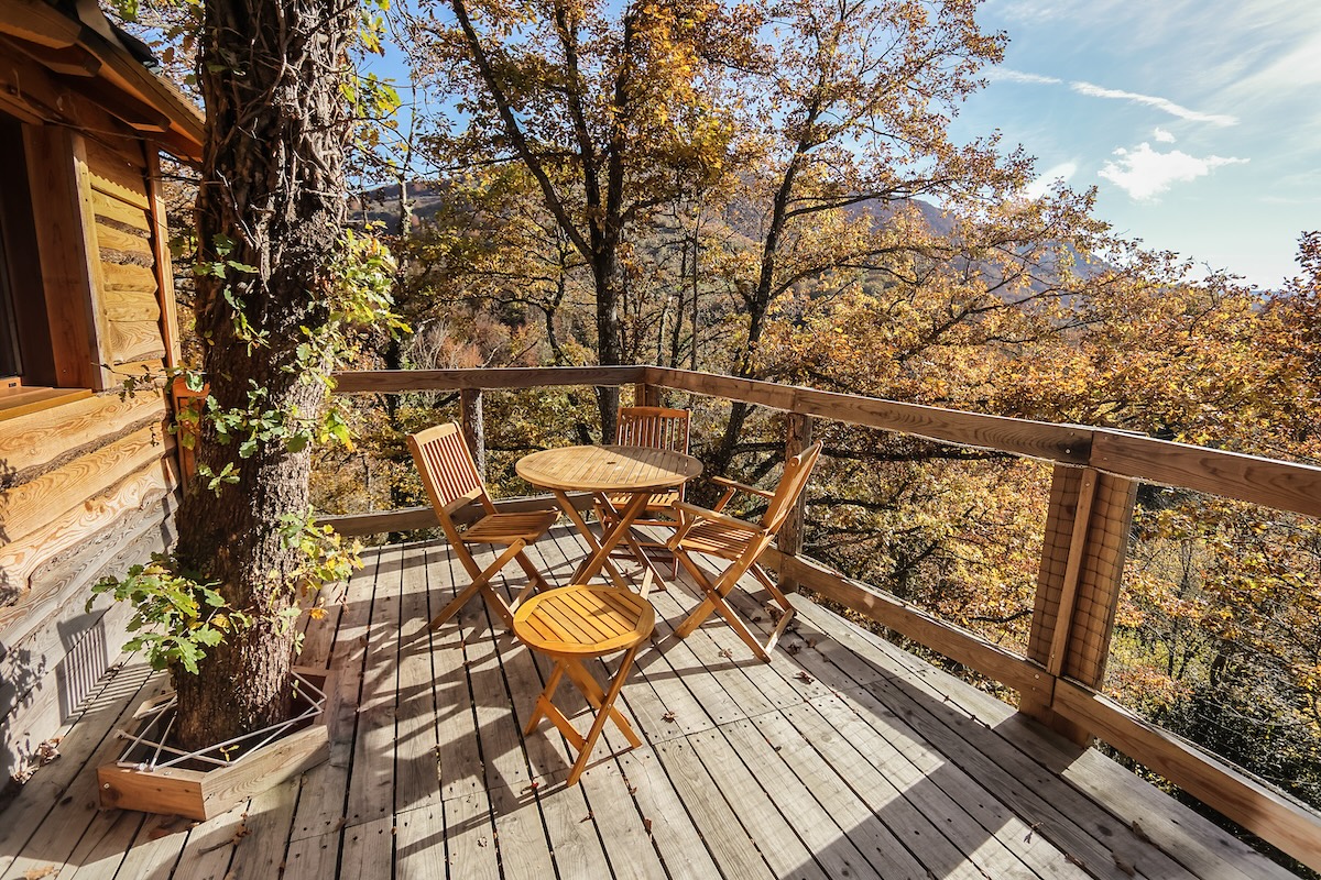 Terraza con mesa y silla de cabaña en el árbol Iratiko Kabiak Arlekia